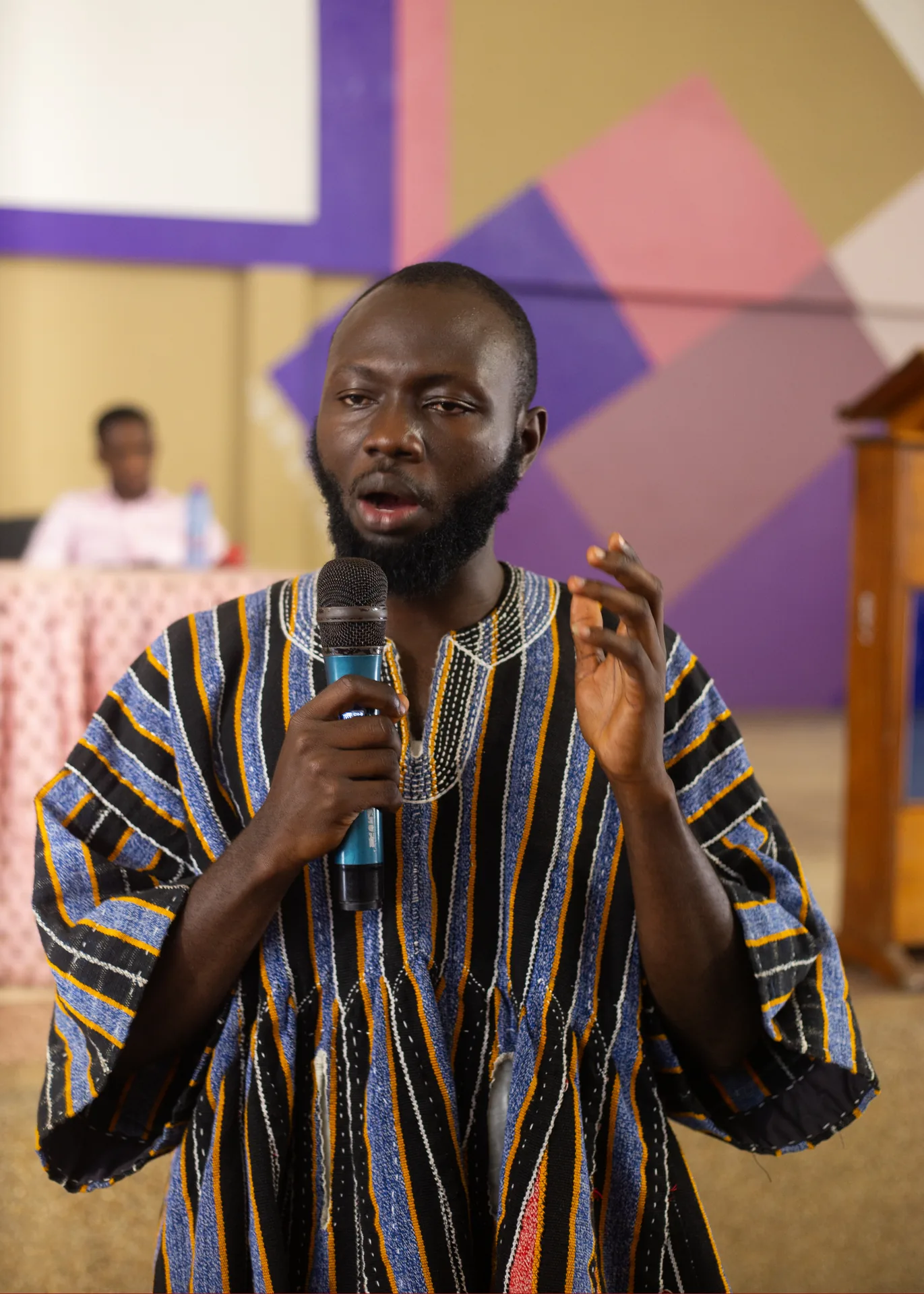A speaker leading a school outreach session
